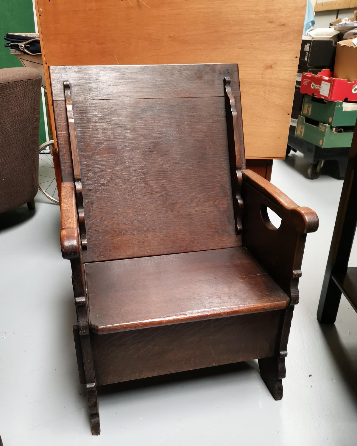 An early 19th century oak monks chair