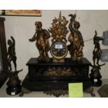 A 19th century clock garniture in black marble and gilt, the clock surmounted by 2 figures, with