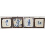 Four Delft blue & white tiles depicting a soldier; acrobats; etc., 12 x 12 cm, framed