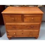 A small pine chest, of 2 long, 2 short shelves and a pine stool