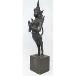 A Thai bronze sculpture of a deity in praying position on wooden plinth height 52cm