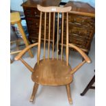 An Ercol light elm stick back rocking armchair