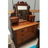 An Edwardian mahogany mirror back dressing chest with 2 long and 2 short drawers and 2 jewellery