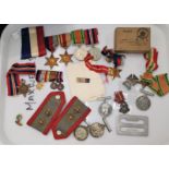 A WWII group of 4 medals together with a Territoral Army Nursing Service cape badge attributed to