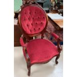 A Victorian mahogany framed armchair, the oval back with carved crest, knurled arms and legs,