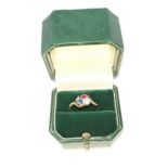 A late 19th Century, early 20th Century gold ring with three stone cluster setting of 2 diamonds,