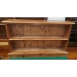 An Edwardian stained wood table with single drawers; a pine 2 height bookcase; a towel rail; a