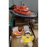 A remote control lifeboat; a Teddy commemorating the 175th anniversary of lifeboats and a lifeboat