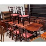 A mahogany reproduction dining suite comprising extending table and 8 (4 + 4) Chippendale style