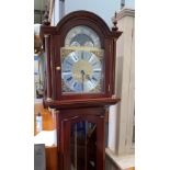 A reproduction Georgian style mahogany longcase clock with arch top, brass dial with moonphase and