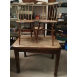 A 1930's oak fold-over dining table and 2 spindle back chairs