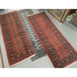 A pair of modern rust ground Bakhara runners, length 180cm, a blue/green runner, length 190 cm