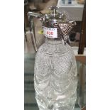 A cut glass claret jug with chased silver plated handle, rim and lid