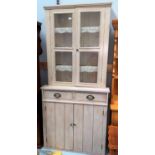 A full height bookcase/display cabinet with 2 upper glazed doors, 2 drawers and double cupboard