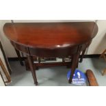 A pair of Georgian style mahogany demi-lune side tables combining to form a dining table with