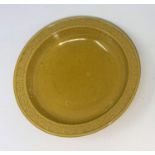 A Chinese yellow glaze dish with exterior dragon motif, mark to base, 13.5cm