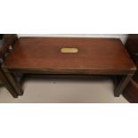 A reproduction coffee table in the military style; a reproduction oak table; another