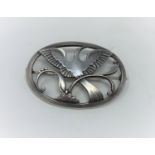 A Georg Jensen silver pierced oval brooch, Bird of Paradise, name impressed in beaded oval,