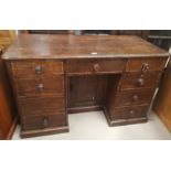 A Victorian elm kneehole desk with 7 drawers and recessed central cupboard, width 133 cm