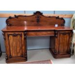 A Victorian figured mahogany sideboard on twin pedestals, with reverse breakfront, acanthus carved