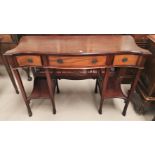 An early 20th century mahogany side/serving table, serpentine front with unusually figured top,
