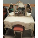 A French style dressing table in cream, with triple mirror and stool