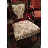 A similar armchair in floral brocade upholstery