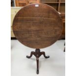 A Georgian occasional table with circular top on turned column tripod base