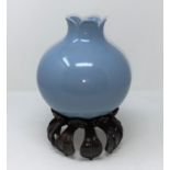 A Chinese blue glaze vase in the form of a pomegranate with mark to base, hardwood stand (some