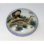 A Chinese porcelain lidded pot decorated with a monkey, mark to base, d 10.5cm