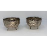 A pair of Middle/Far Eastern white metal bowls with extensive embossed decoration, dia 9cm (
