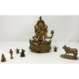A gilt figure of a Tibetan Buddha, ht 23cm; other similar miniature figures