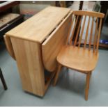 A modern lightwood drop leaf kitchen table and 4 stick back chairs