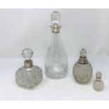 A mallet shaped decanter with silver rim; 3 cut glass scent bottles with hallmarked silver collars