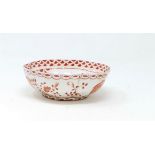 A Chinese porcelain scalloped bowl decorated inside and out with flowers, fish scale border in