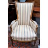 A period style continental high back armchair in carved walnut frame in pink and grey striped fabric
