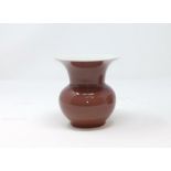 A Chinese pale red 'spitoon' vase with flared rim, height 11cm
