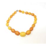 An unpolished amber necklace, 78gm, largest bead 3cm, overall length 46cm