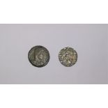 A copper Roman coin, a silver coloured Middle Eastern coin