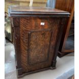 An early 20th century "New Ideal" treadle sewing machine in oak cabinet