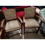 A pair of 1930's oak framed open armchair in patterned tapestry fabric