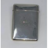 A silver trinket box of elongated oval form; a silver card case; a silver backed brush