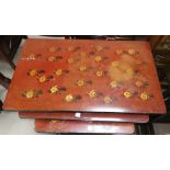 An oriental nest of 3 occasional tables in red lacquer