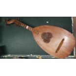 An early 20th century 10 string lute/guitar with fretted sound hole and wooden pegs