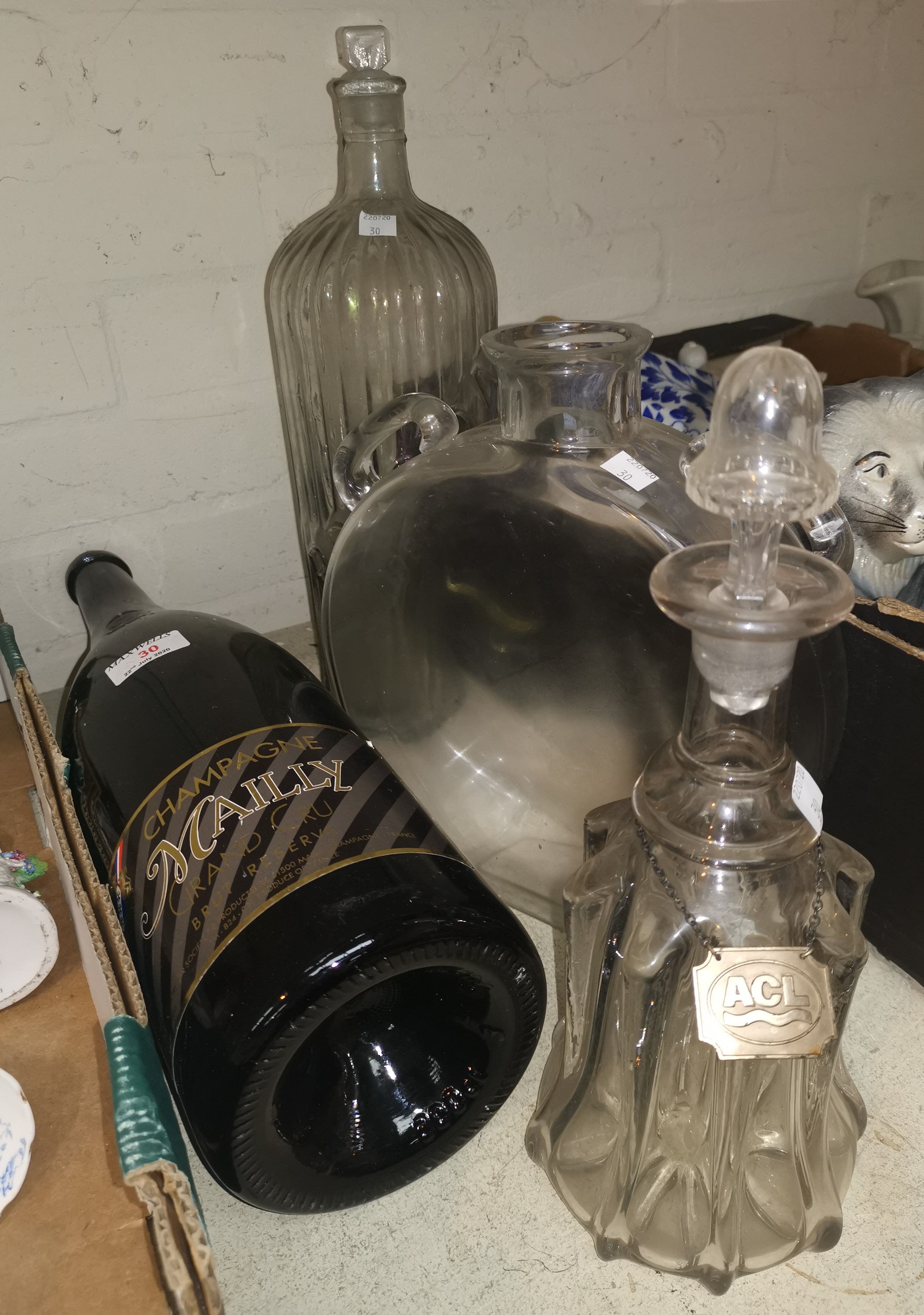 A large champagne bottle, a large poison bottle and glassware