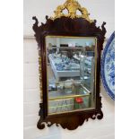 A wall mirror in parcel gilt Chippendale style frame