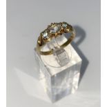 A 9 carat hallmarked gold dress ring set with 3 aquamarine stones, size O, 3gm