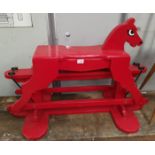 A vintage red wooden rocking horse