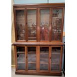 An early 20th century mahogany library bookcase with 4 glazed doors to the upper section and base,