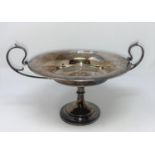 A 1920's hallmarked silver pedestal dish with curved double handles with later presentation